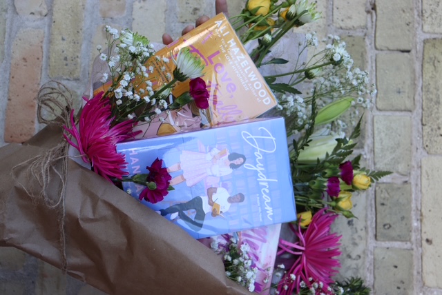 Books wrapped with fresh flowers like a floral bouquet